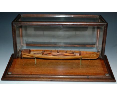 An early 20th century scratch built model, of a rowing scull, the boat 34cm long, glazed case, plinth base, 19cm high, 47cm w