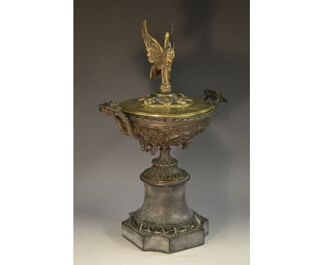 A 19th century Grand Tour bronze wine cup and cover, the dark patinated kylix boldly cast with Bacchic putti within roundels,