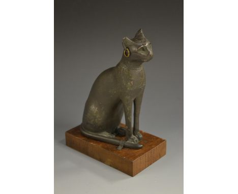 A museum-type composite model, after the Ancient Egyptian, of a cat, mahogany base, 17cm high 