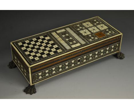 A 19th century Anglo-Indian sandalwood and Sadeli marquetry games box, hinged cover inlaid for chess, cribbage and other parl