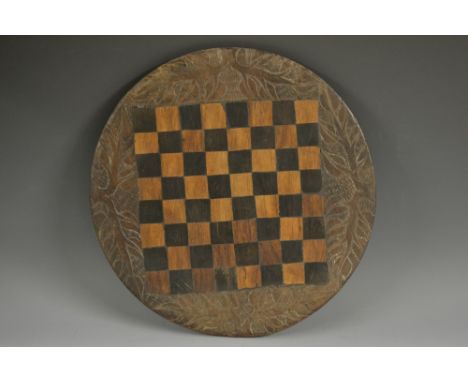 Folk Art - a 19th century hardwood circular chess board, naively carved to border and verso with leafy branches and zebras, 3