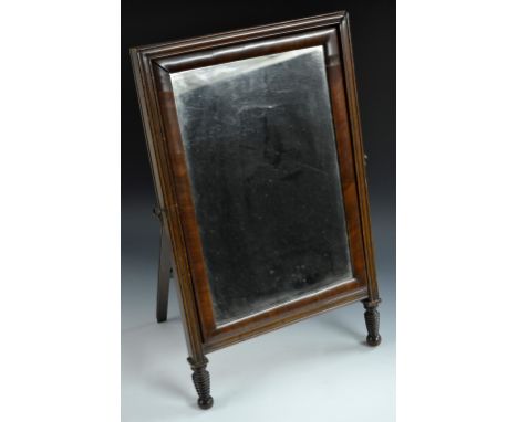 An unusual Victorian mahogany 'Campaign' easel back dressing glass, cushion framed tilting rectangular glass, within a reeded
