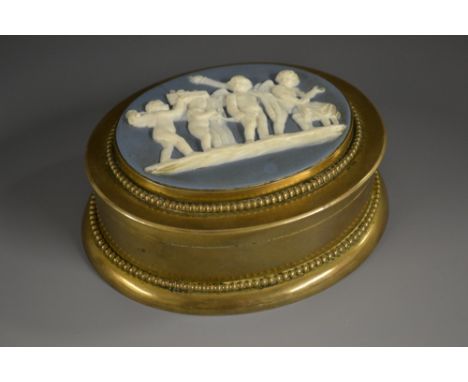 A 19th century jasperware mounted gilt brass table snuff box, hinged cover sprigged with Classical putti, beaded bezel and bo