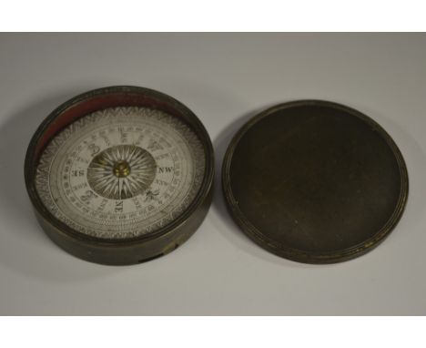 A 19th century circular brass pocket compass, 6.5cm paper register, push cover cast with two fillets, 7.5cm diam overall 