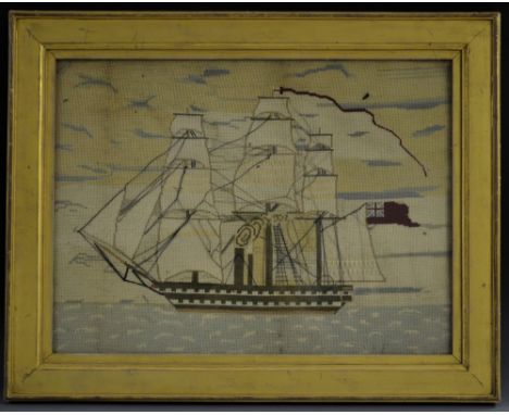 A 19th century sailor's woolwork picture, worked in coloured threads with a ship of the fleet, 44.5cm x 60cm, c.1850, gilt fr