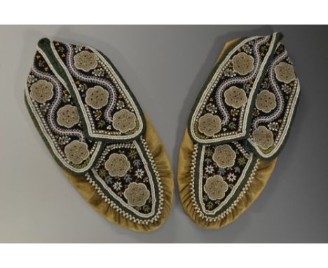 Tribal Art - a pair of Native American child's suede moccasins, brightly decorated in beadwork with stylized floral motifs, 1