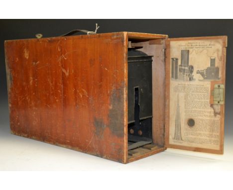 An early 20th century magic lantern, by Newton & Co, London, 46cm long, mahogany case with paper label