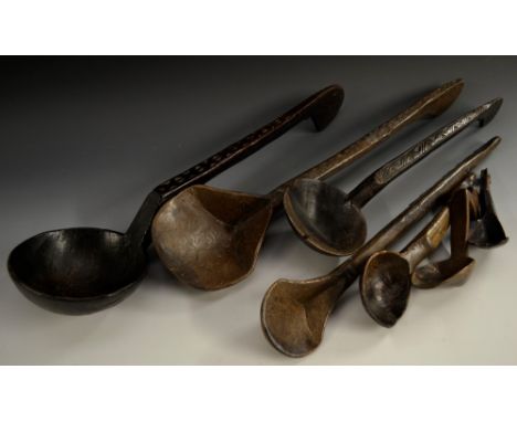  A large hardwood ladle, chip-carved stem, 55cm long; other spoons, similar