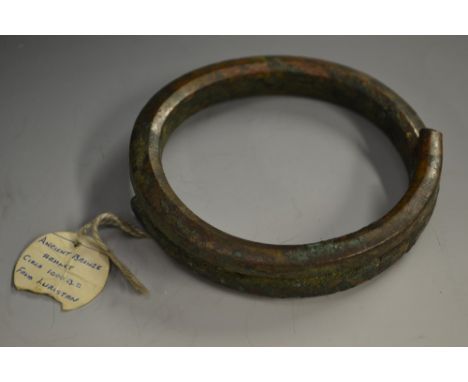 Antiquities - an Ancient Luristan verdigris patinated bronze armlet or amulet, of coiled form, 10.5cm diam, Lorestan Province