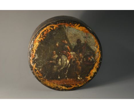 A late 18th century japanned circular snuff box, the cover painted in the manner of an Old Master, the side and base gilt wit