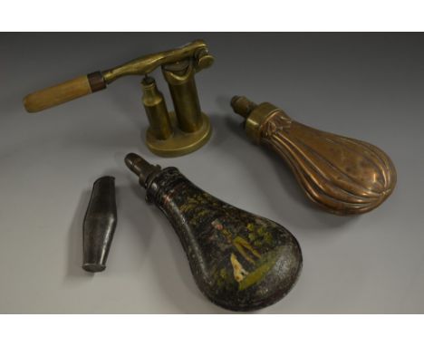 A 19th century toleware shot flask, painted with a sportsman and his dog, he stands, loading his rifle with the ramrod, brass