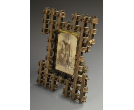 Cycling - a Victorian tramp art easel photograph frame, containing a photograph of a man with a penny farthing or ordinary bi