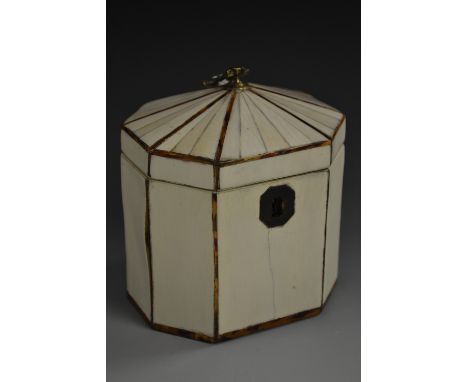 A 'George III' tortoiseshell crossbanded ivory octagonal tea caddy, hinged cover with brass axe head finial, 12.5cm high 