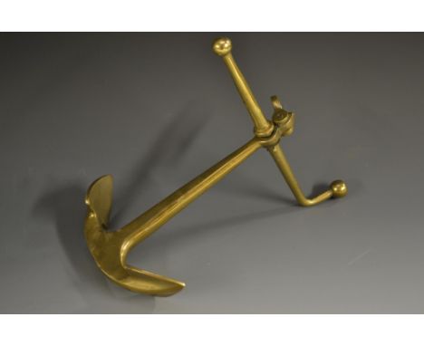 A Victorian gilt brass novelty desk weight, cast as a ship's anchor, axe head handle, 19cm long, c.1880