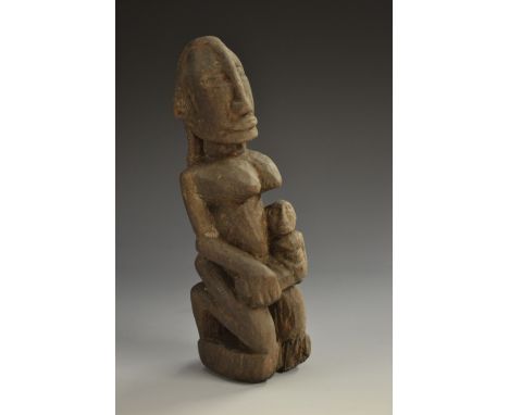 Tribal Art - an African fertility figure, she kneels, an infant in her arms, 17cm high 