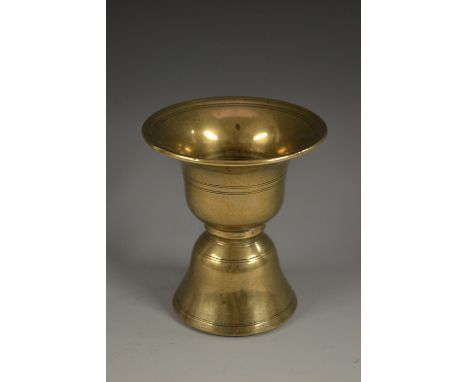 A Tibetan bronze waisted bell shaped butter lamp, of Islamic shape, 11cm high, 18th century