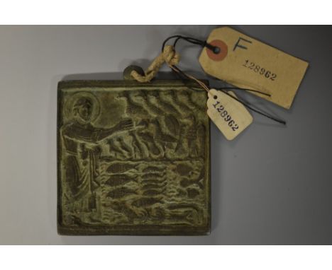 A Coptic verdigris patinated bronze icon, cast in relief with a figure in benediction, before the birds of the sky and the fi