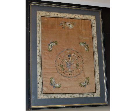 A Chinese silk panel, finely worked in coloured and gold threads with Guanyin and attendants, within a roundel outlined by ba