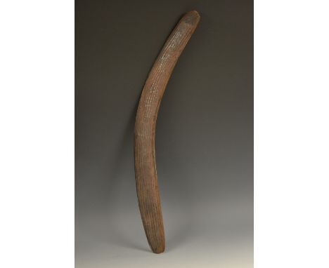 Tribal Art - an Australian Aboriginal boomerang, wavy stone carved texture, traces of pigment, 61cm long, 19th/early 20th cen