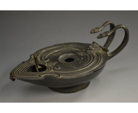 A 19th century dark patinated lamp, in the Roman manner, hinged cover enclosing a rotating mechanism, serpent handles, 17cm l