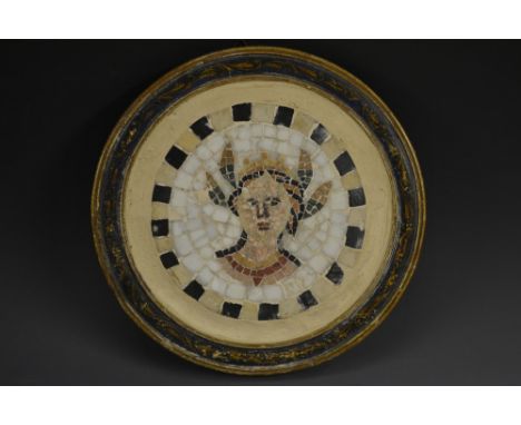 A Grand Tour circular mosaic panel, decorated in coloured tesserae with a maiden, wearing a laureate garland, painted softwoo