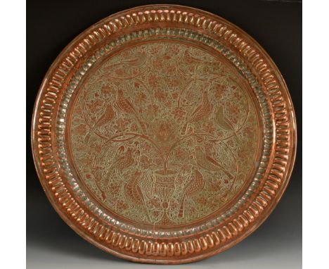A 19th century Anglo-Indian/Persian Masonic copper charger, fluted border, the field chased with stylised birds amongst fruit