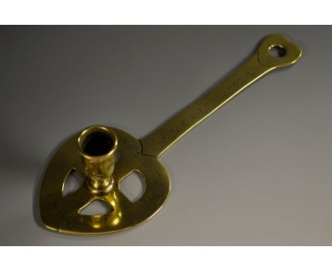 An unusual Scottish brass pan-handled chamber stick, slender campana sconce, heart shaped plateau and terminal, 25cm long, in