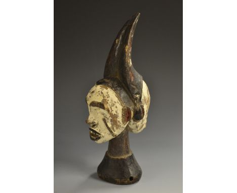 Tribal Art - an African softwood double-faced head ornament, scarified features, white and red pigment, 22cm high 