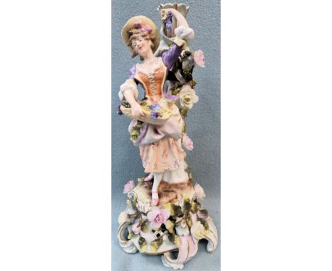 Meissen style figure form relief decorated ceramic candlestick. Approx. 35cms H
used with minor chips to petals etc in variou