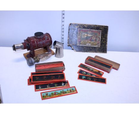 A vintage child's magic lantern and selection of glass slides 