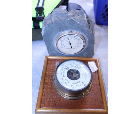 A vintage thermometer and brass barometer 