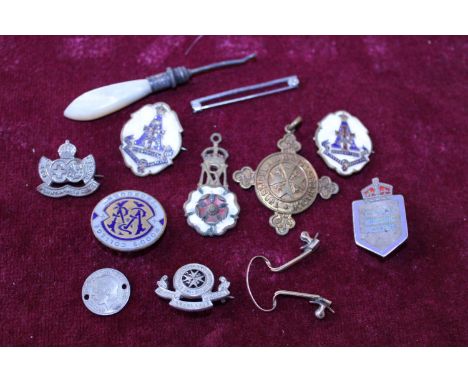 A selection of assorted enamel badges and other items 