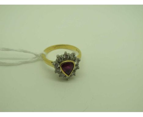 An 18ct Gold Ruby and Diamond Cluster Ring, collet rubover set to the centre, within border of uniform brilliant cut stones (