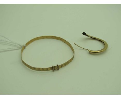 A Child's Expanding Bangle, stamped "375" (bent); together with an odd earring (damages).