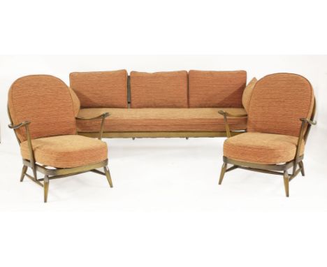 An Ercol lounge suite,upholstered with orange cushions, comprising:a day bed,190cm wide, anda pair of armchairs,80cm wide (3)