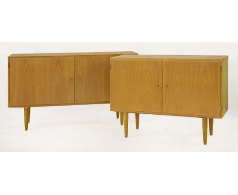 Two Danish oak cupboards,by Hundevad, each with adjustable shelves, on turned legs, with 'Danish Furniture Makers' Control' l
