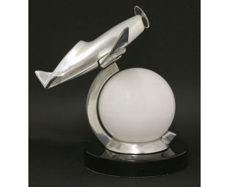 An Art Deco-style chrome table lamp, modelled as a fighter plane, with a frosted glass globe, on a painted circular plinth, c