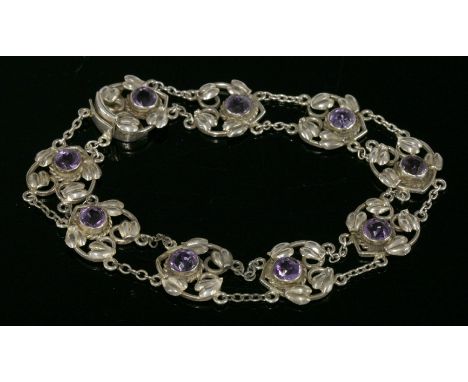 A sterling silver Arts and Crafts amethyst bracelet,with a series of wire heart-shaped plaques, each one rub set with a circu
