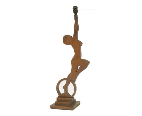 An Art Deco pine fret cut table lamp,in the form of a lady holding the fitting,60cm high