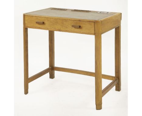 An Art Deco walnut writing table,the faded leather top with a chrome inkwell, letter rack and pen tray, over a single drawer,