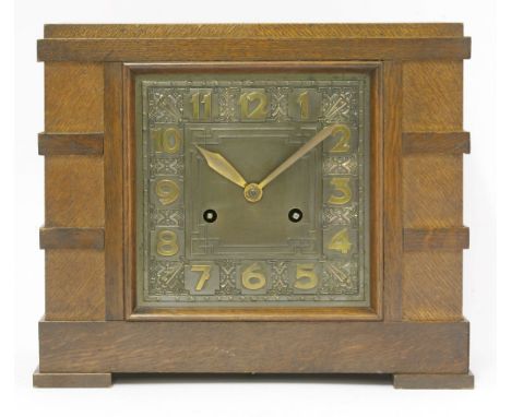 An Art Deco oak-cased mantel clock,with an embossed metal dial,29cm wide