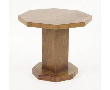 An Art Deco octagonal walnut lamp table,the segmented top over a square, oak veneered column, raised on an octagonal plinth,4