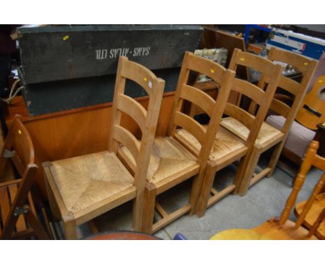 A set of four beech ladder back chairs