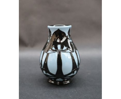 A Moorcroft pottery vase decorated with trees silhouetted against a light blue ground, impressed mark, dated 2008, 10cm high 
