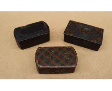 A papier mache snuff box of rectangular form with tartan decoration, together with two other papier mache snuff boxes