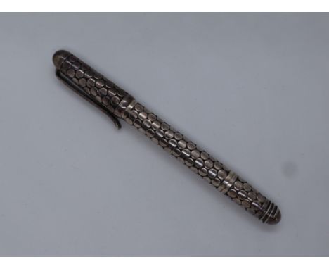 A silver roller ball pen, with body decorated with flat circular disks, marked 925, 