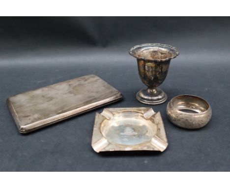 A George V silver cigarette case, London, 1933, together with a silver ashtray, egg cup and napkin ring, approximately 250 gr