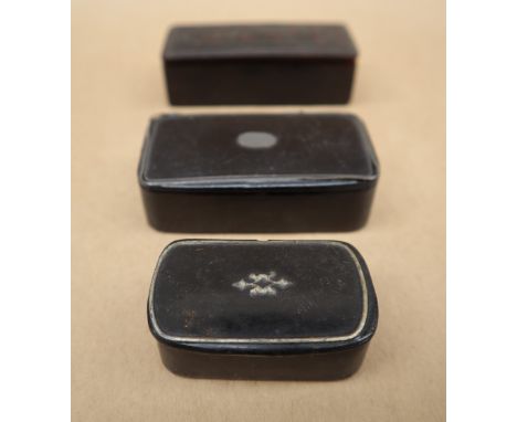 A papier mache snuff box of rectangular form with line decoration, together with two other snuff boxes 