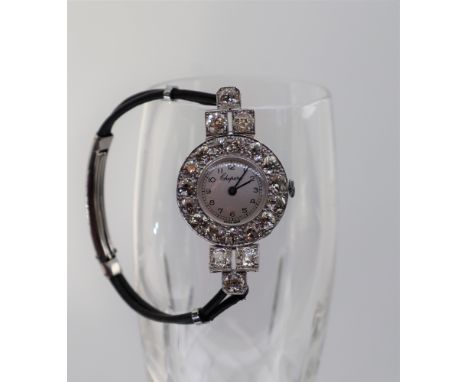 A lady's Chopard wristwatch, set with round old cut diamonds to a white metal setting on a black leather strap