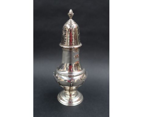 A George V silver sugar caster with an acorn finial and pierced domed cover and a line decorated baluster body and spreading 